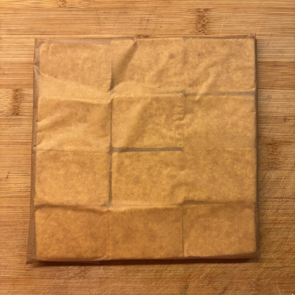 Butterstücke in ein Backpapier eingeschlagen.